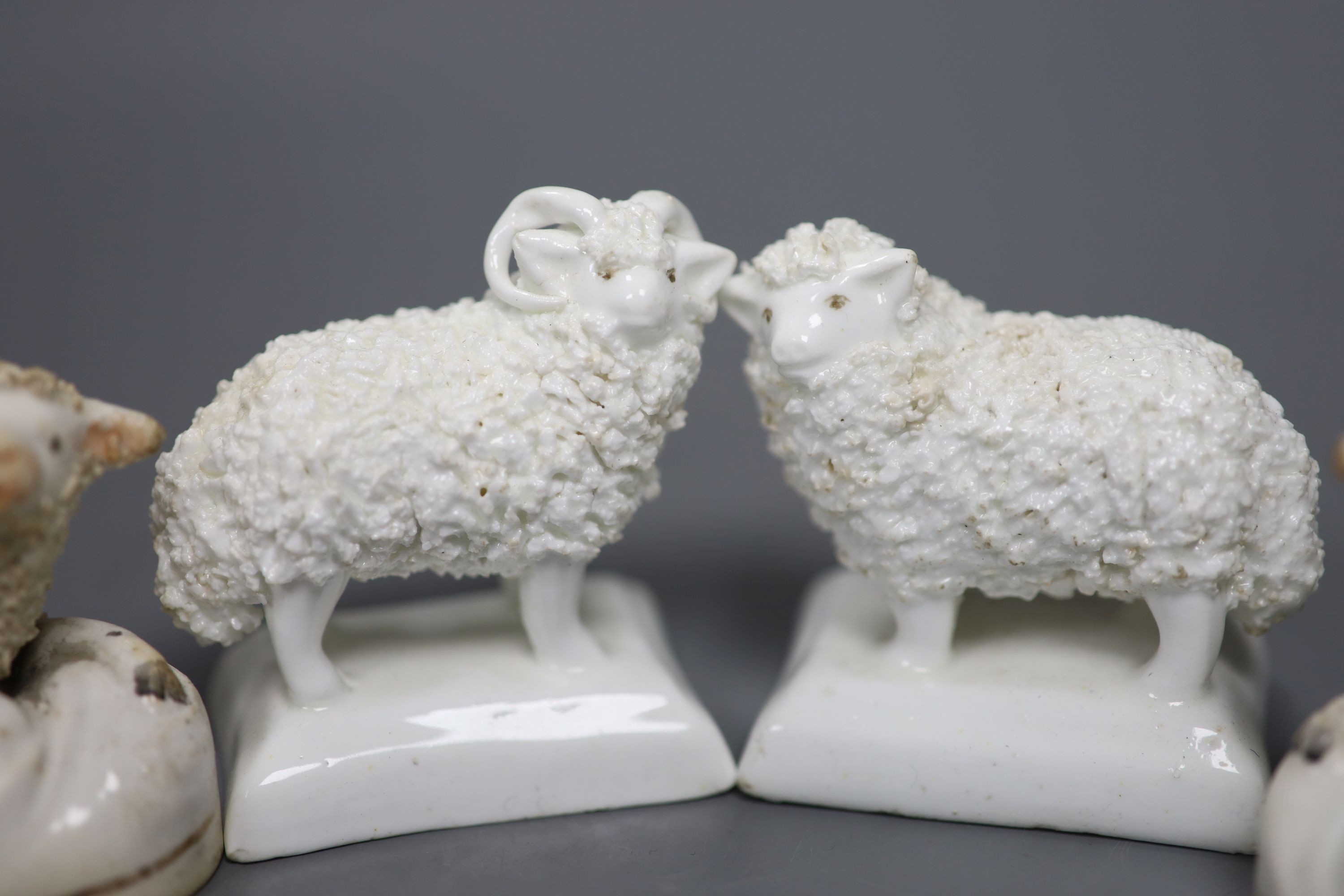 Two pairs of Staffordshire porcelain figures of sheep and two similar ‘sheep’ spill vases, c.1830-50, tallest 8.5 cm